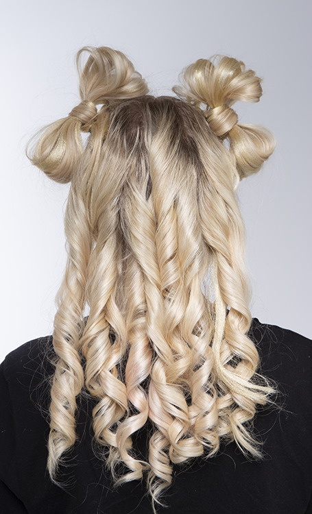 Back of student's head showing hair styled into two bows