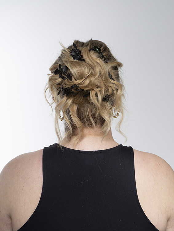 Back of student's head showing hair styled into a bun with waves