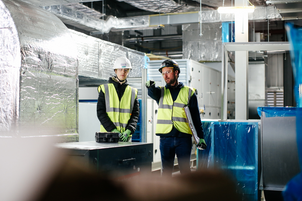 Student standing holding a book