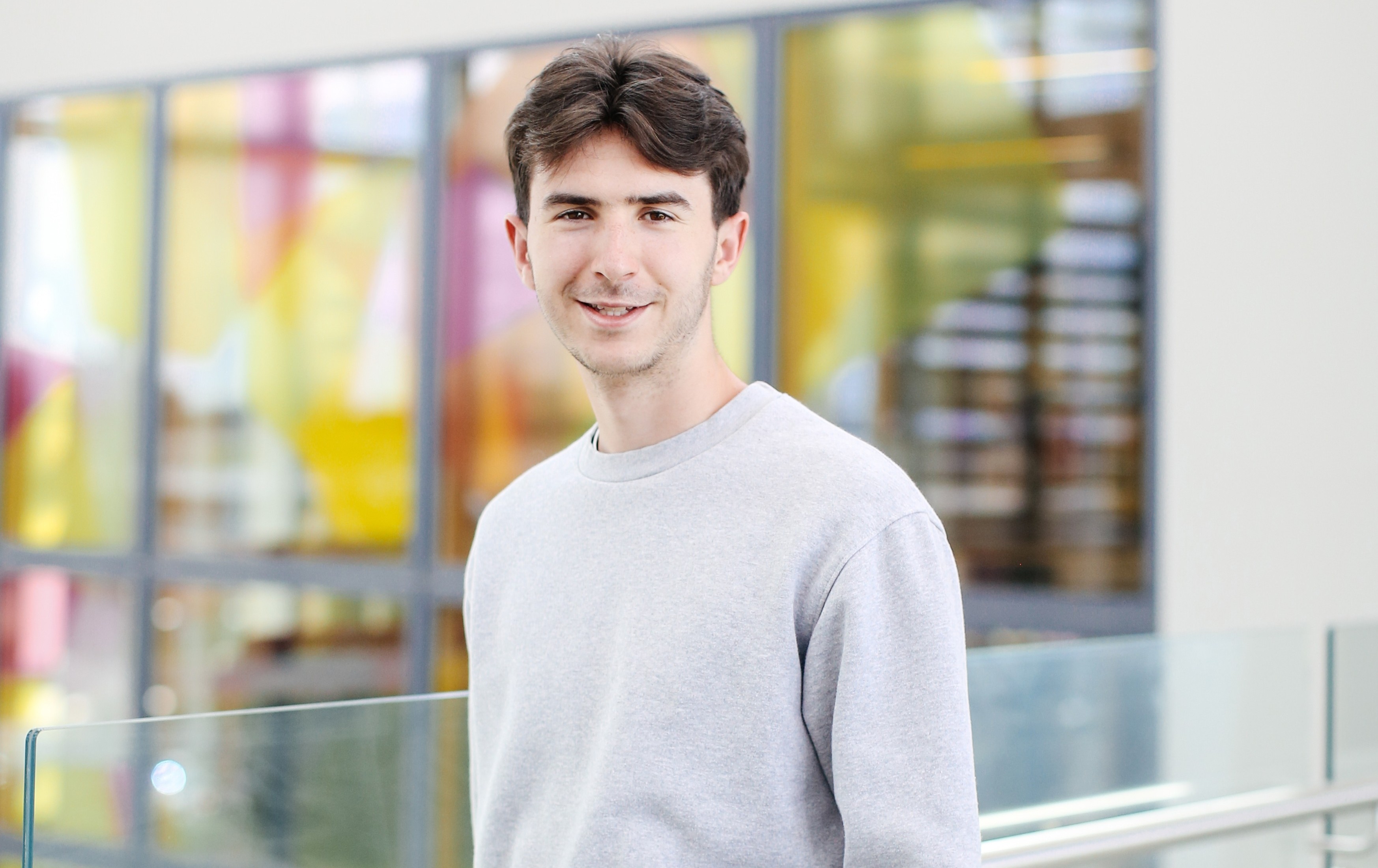 Student standing holding a book