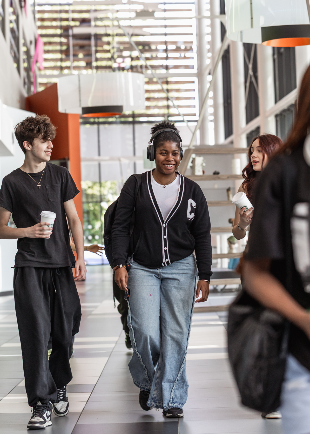 Students smiling walking outside campus