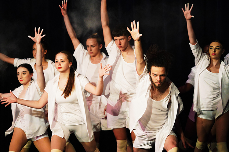 Group of students acting in white