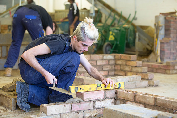 Measuring brick wall level with spirit level measurer