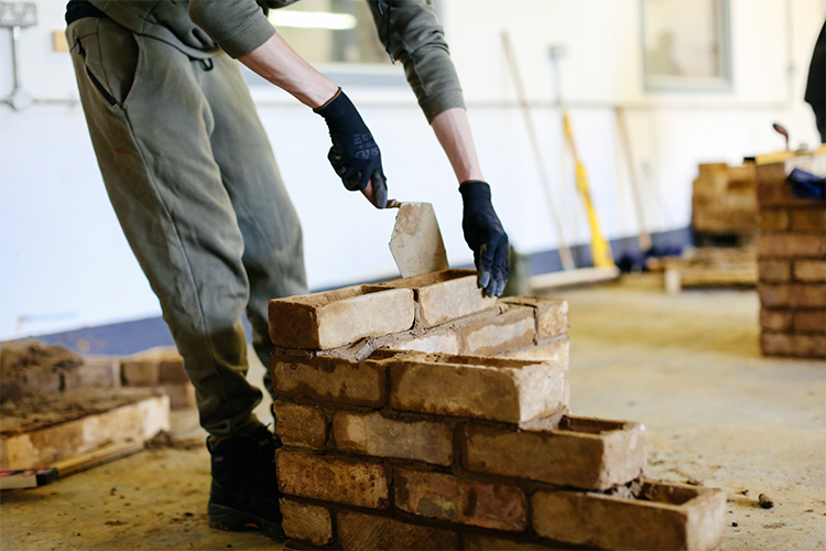 Student laying bricks