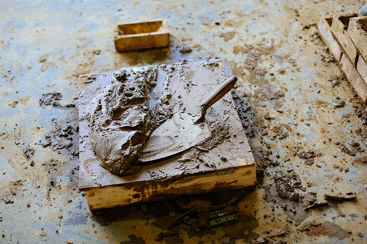Trowel, cement and bricks