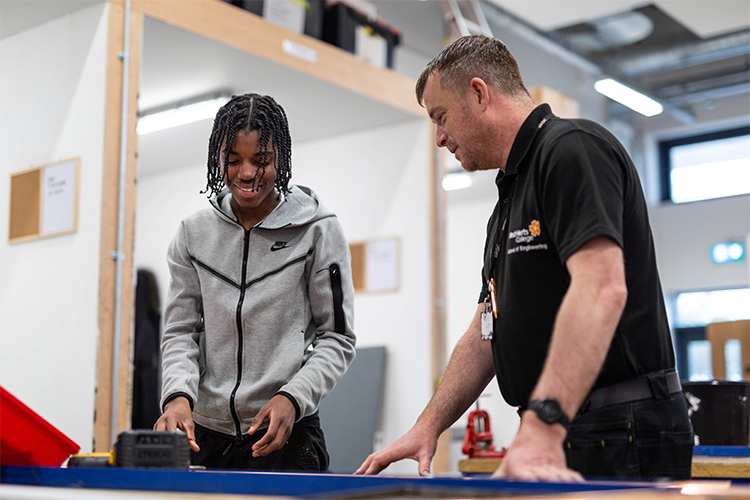 Teacher teaching student about plumbing