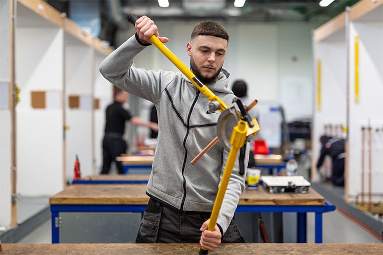 Student resizing a pipe