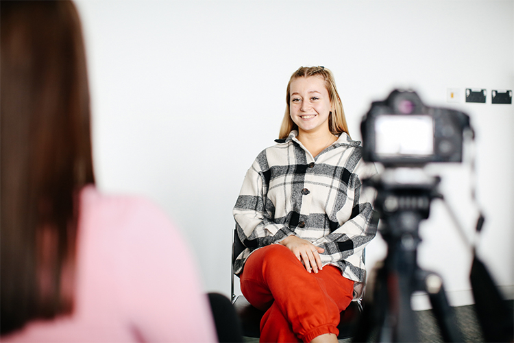 student in front of camera