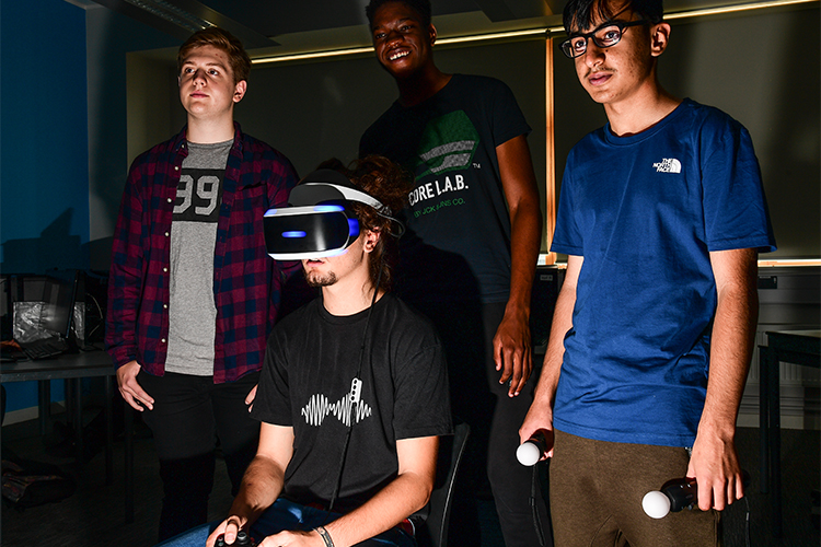 digital gaming group of students playing with VR