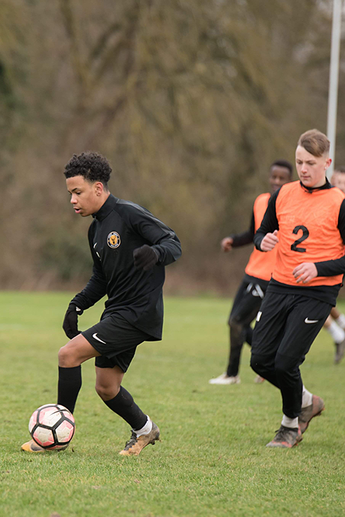 Footballers playing on a pitch