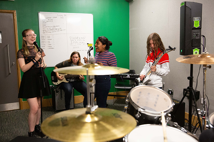 Students singing and playing guitar