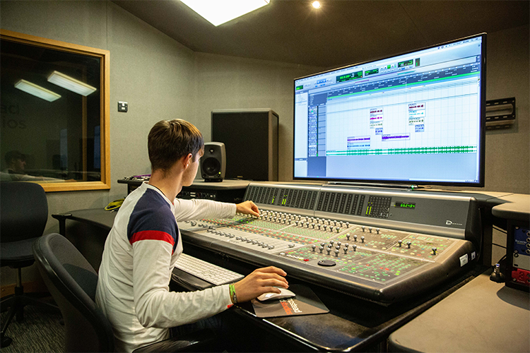 Student using producing equipment and software
