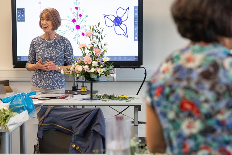 Tutor talking to class with flowers