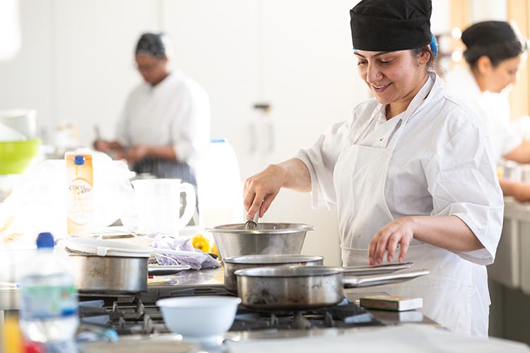 Student mixing food in a bowl