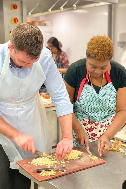 2 students chopping vegetables