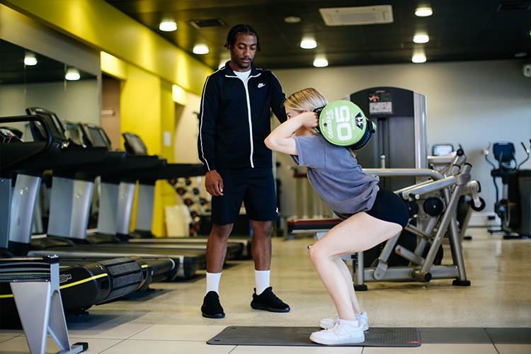Student doing leg exercises with weights