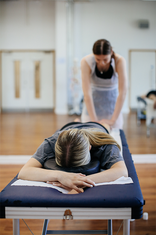 Student giving another student a massage