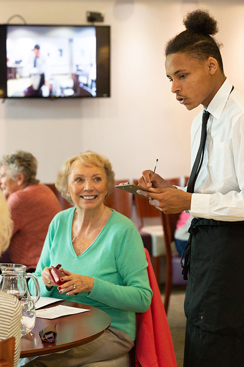 student taking a customer's order