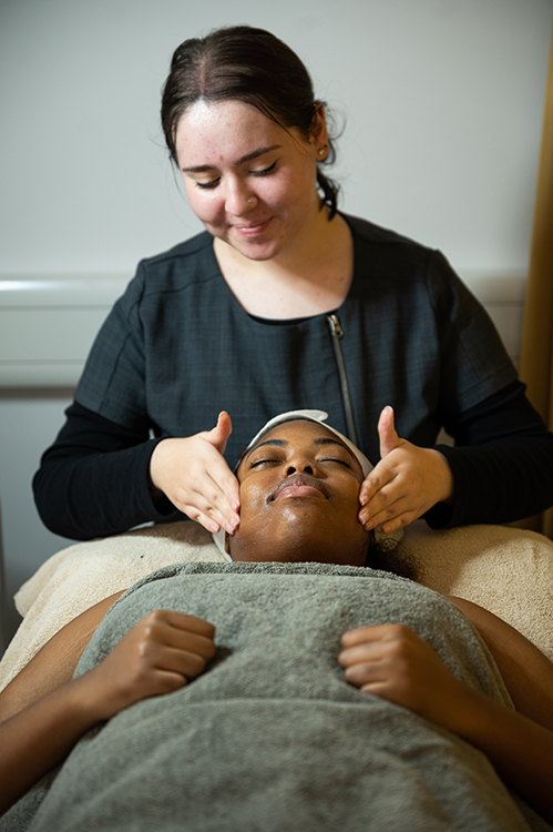 Student giving someone a facial