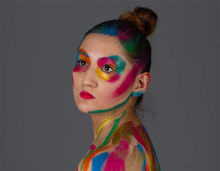 Student with colourful makeup posing