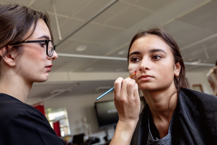 Student working on a hair and media make-up project