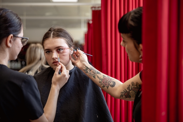 Students working on a hair and media make-up project