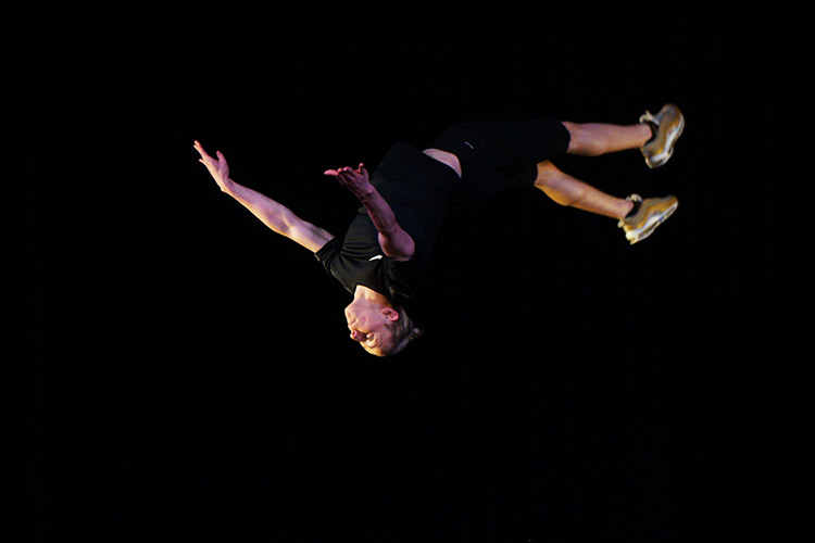 student dancing back flip