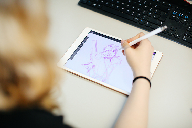 student drawing on a tablet
