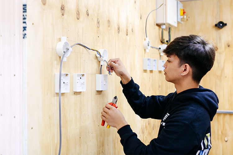 Student fixing some wires