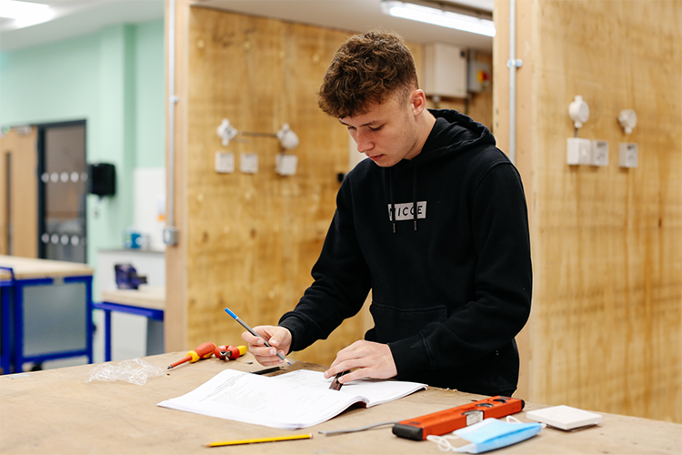 Student reading an instruction manual