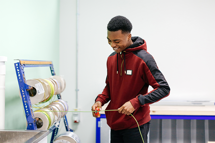 Student gathering some wires