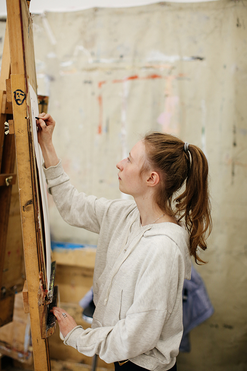 Student painting on a canvas