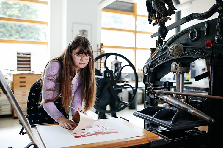 Student looking at screen printed work