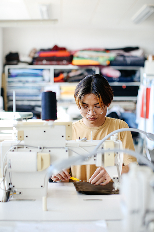 Boy using sewing machine