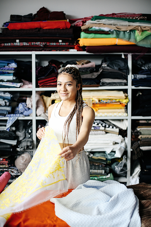 Girl holding yellow embroidered fabric