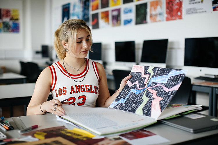 Student looking at sketchbook