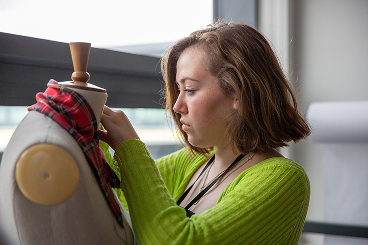 Student dressing a mannequin
