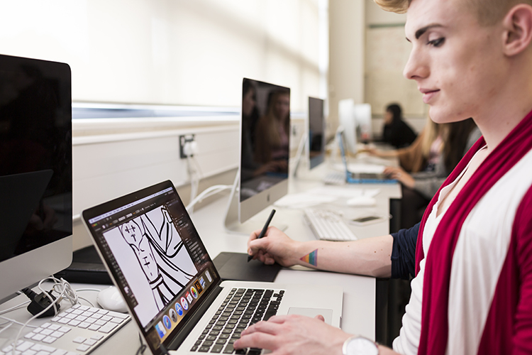 Student designing clothing on a computer