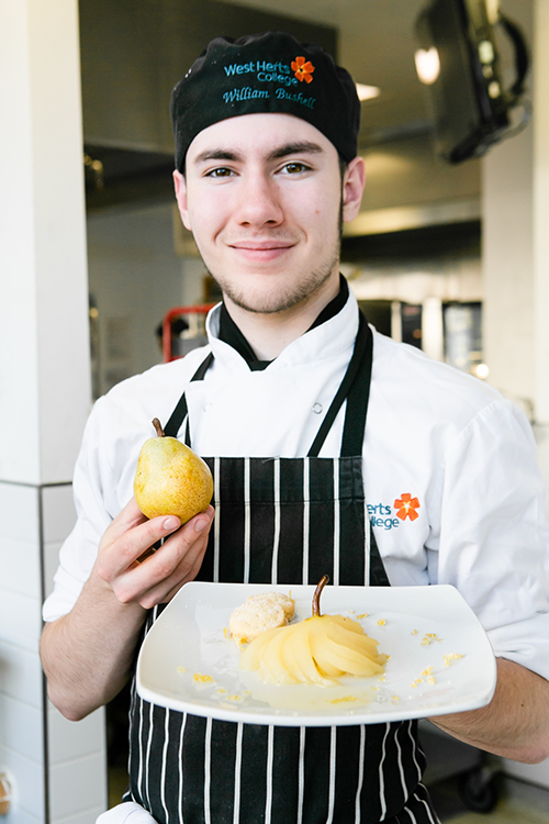 student holding a pear