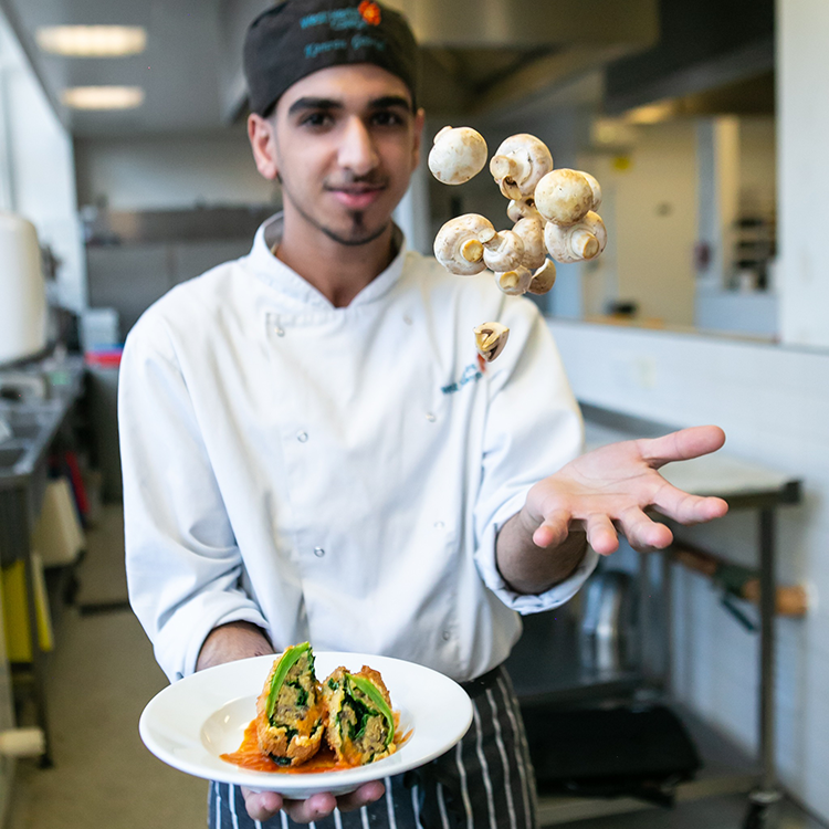 student holding plate of food