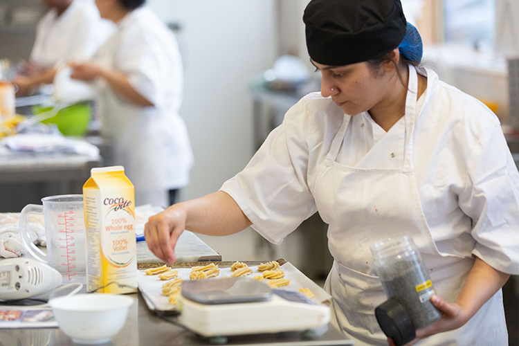 student decorating pastries
