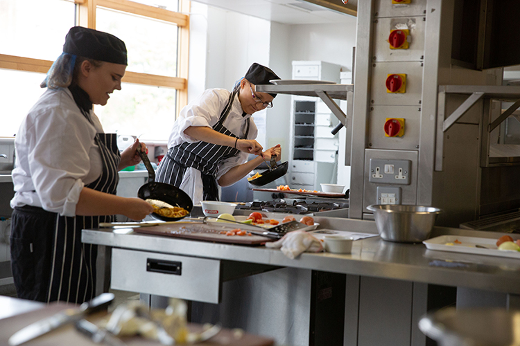 Students frying food