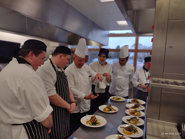 students gathered around plates of food