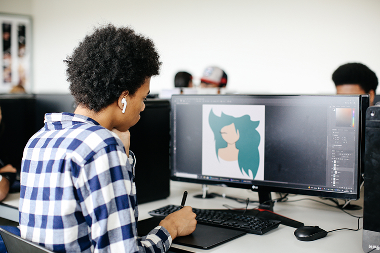 Student using drawing tablet to create digital illustration