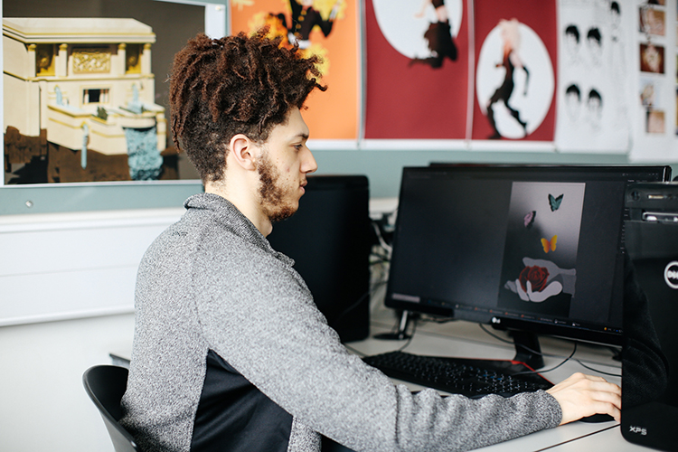 Student creating digital illustration on a computer