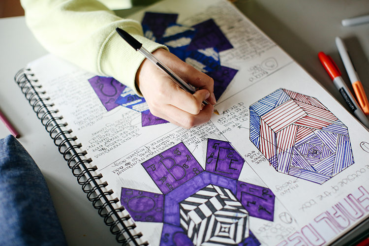 Student drawing a detailed design