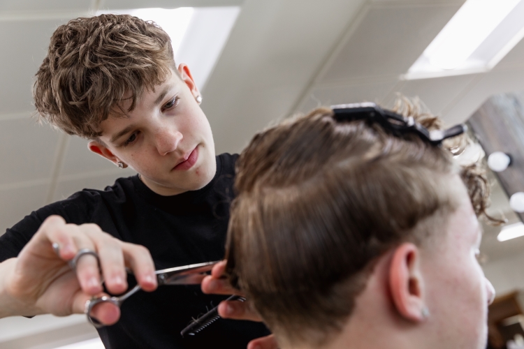 Student working on a barbering project