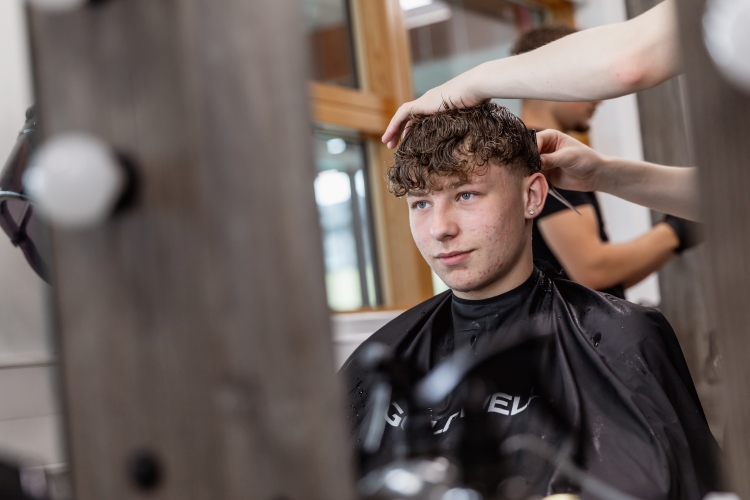 Student working on a barbering project