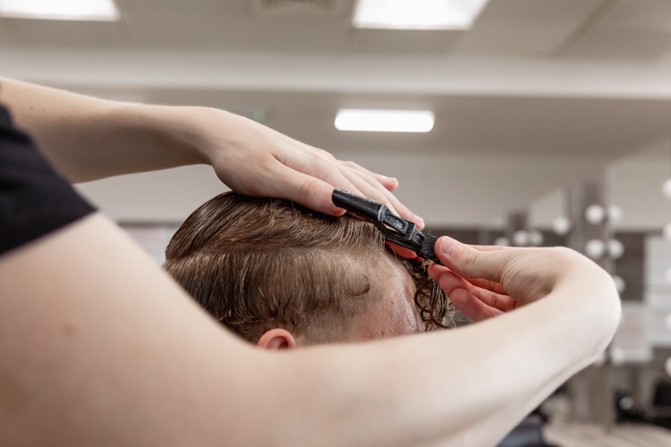 Student working on a barbering project