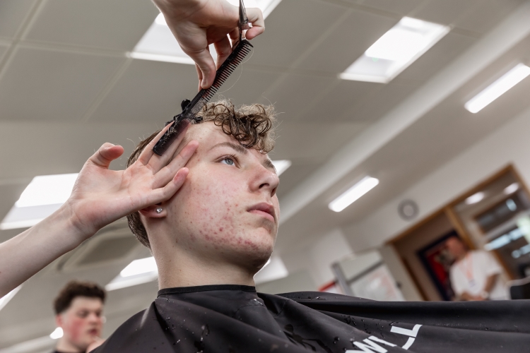 Student working on a barbering project